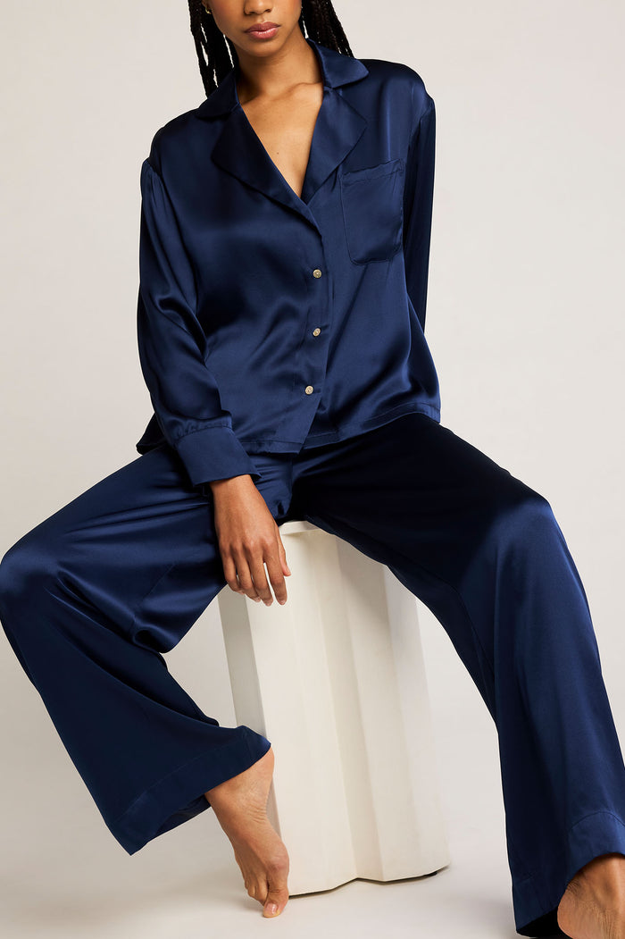 Navy button-up shirt with pointed collar, long sleeves, and buttoned cuffs