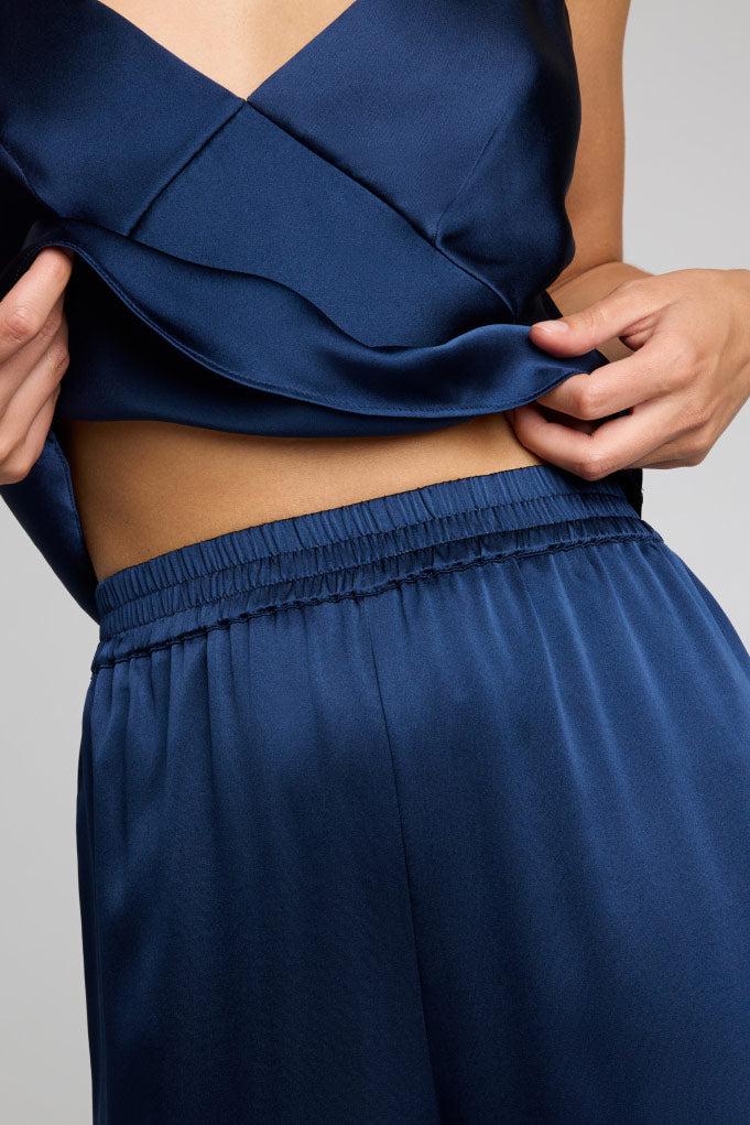 Navy silk track pants with elastic waistband and gathered waist detail