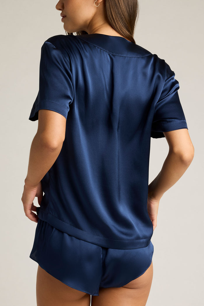 Navy washable silk top with short sleeves and gathered back hem, relaxed fit