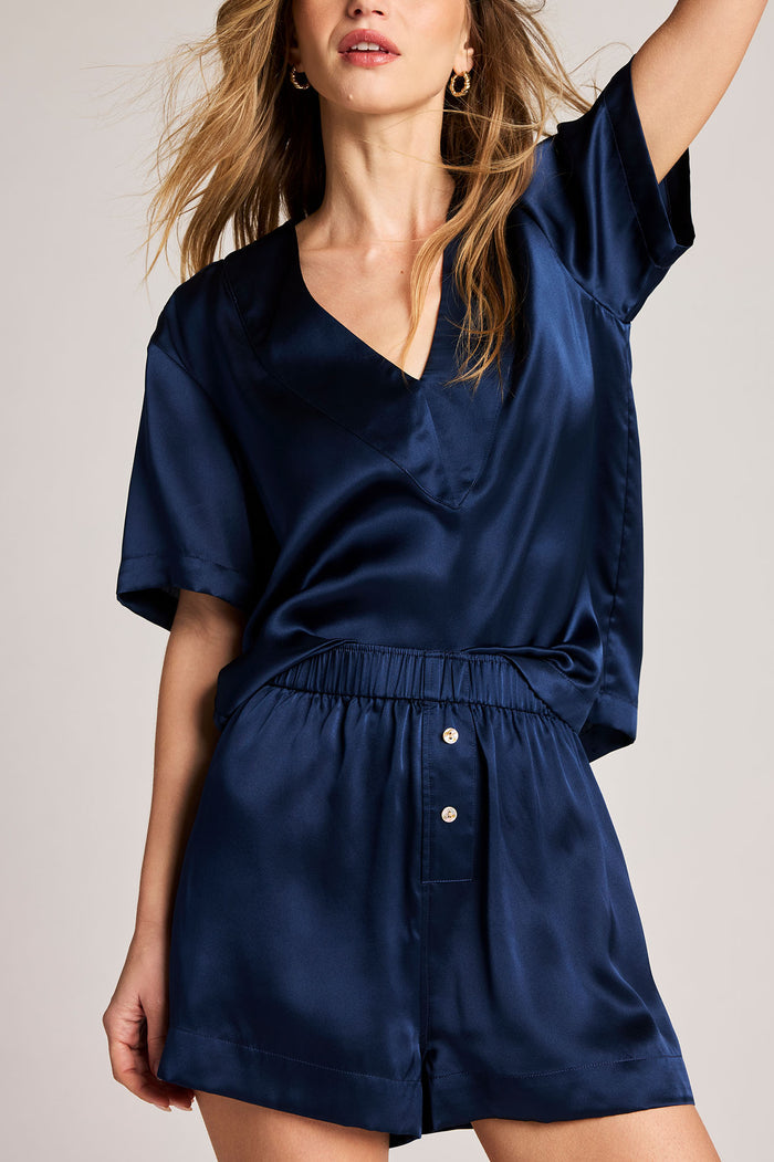 Navy washable silk V-neck top with short sleeves and elastic waist, paired shorts