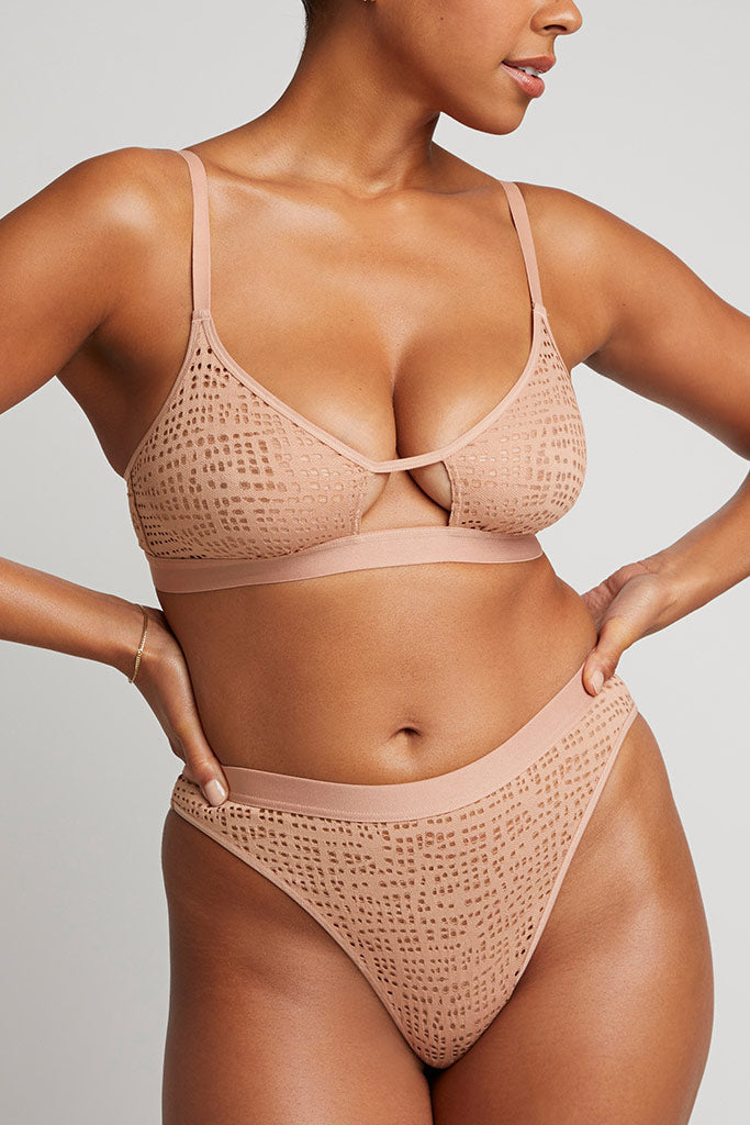 Buff eyelet lace cutout bra with crisscross center tie; matching lace briefs, front view