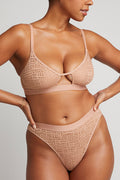 Buff eyelet lace cutout bra with crisscross center tie; matching lace briefs, front view