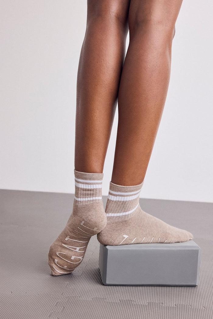 Tan ankle socks with striped cuffs and grippy sole pattern