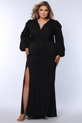 Plus size long black evening dress with deep v-neckline, pleated waistband, ruchsed skirt with high slit. Long puff sleeves with elastic at the wrist.  CE2502 available in sizes 14-24 in black. Celebrations by Sydney's Closet.