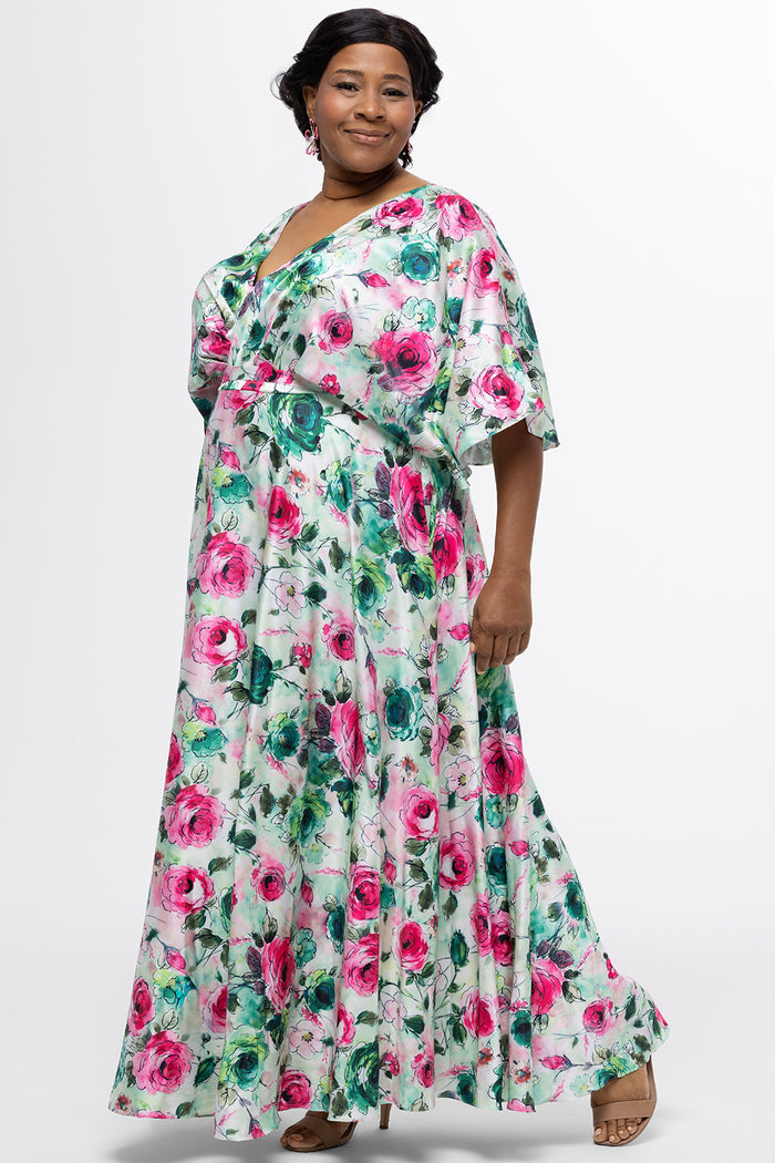 Celebration's by Sydney's Closet style CE2619 in floral. 

Empire waist, satin plus size floral gown with surplice bodice, V-neck and elbow length sleeves. Ankle length A-line skirt, center back zipper and pockets.  Includes optional belt.