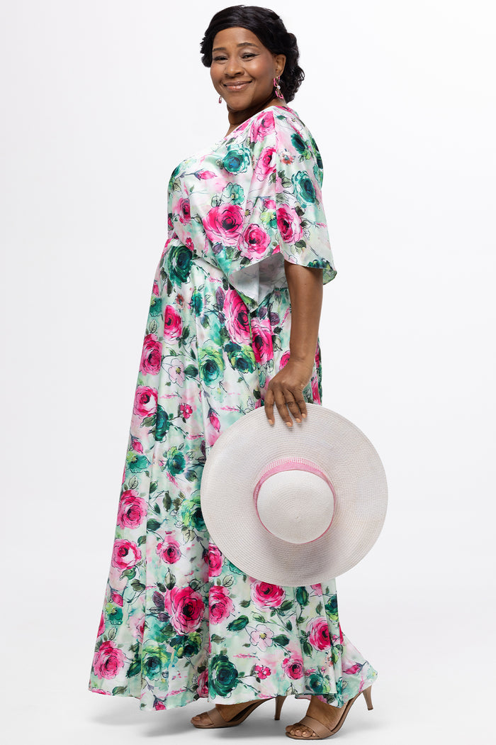 Celebration's by Sydney's Closet style CE2619 in floral. 

Empire waist, satin plus size floral gown with surplice bodice, V-neck and elbow length sleeves. Ankle length A-line skirt, center back zipper and pockets.  Includes optional belt.