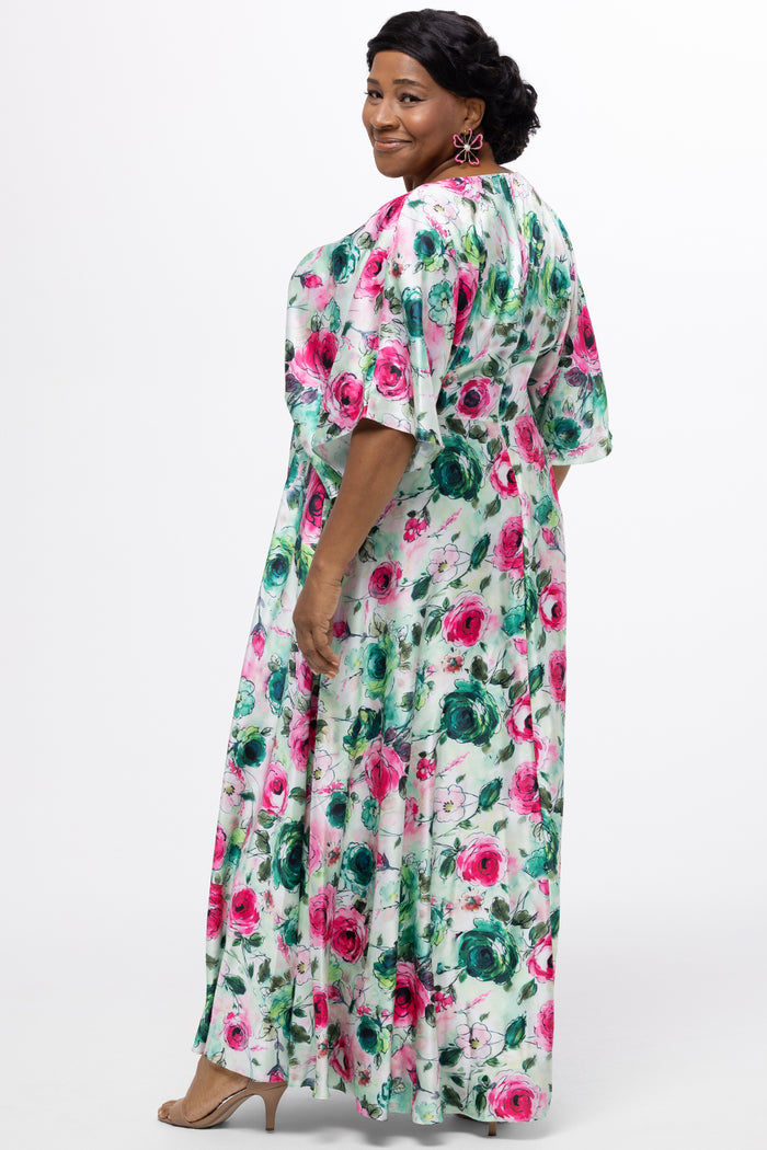 Celebration's by Sydney's Closet style CE2619 in floral. 

Empire waist, satin plus size floral gown with surplice bodice, V-neck and elbow length sleeves. Ankle length A-line skirt, center back zipper and pockets.  Includes optional belt.
