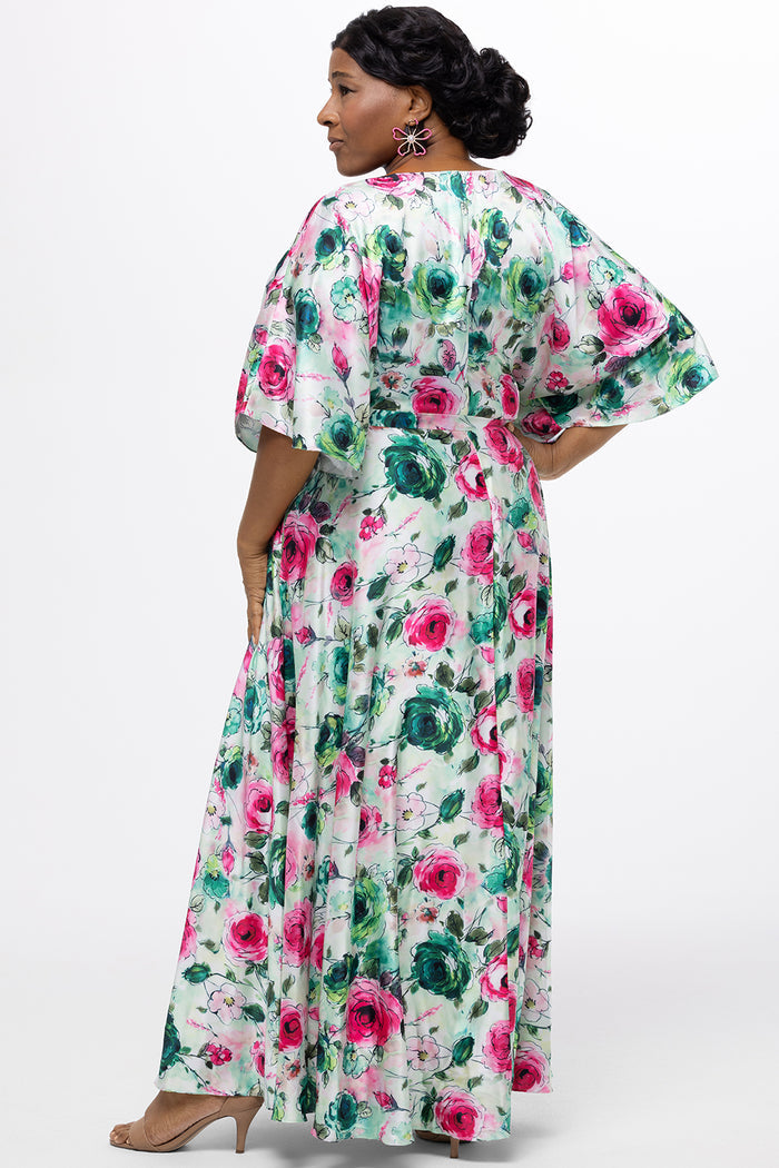 Celebration's by Sydney's Closet style CE2619 in floral. 

Empire waist, satin plus size floral gown with surplice bodice, V-neck and elbow length sleeves. Ankle length A-line skirt, center back zipper and pockets.  Includes optional belt.
