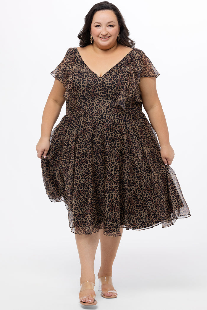 Celebrations by Sydney's Closet style CE2605 in animal print. 

Knee length plus size animal print dress.  V-neck, short flutter sleeves, natural waistline, pockets and ruffles on bodice princess seams. Made from printed chiffon and light satin lining. Center back zipper.