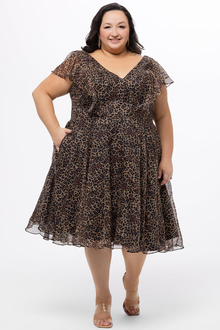 Celebrations by Sydney's Closet style CE2605 in animal print. 

Knee length plus size animal print dress.  V-neck, short flutter sleeves, natural waistline, pockets and ruffles on bodice princess seams. Made from printed chiffon and light satin lining. Center back zipper.