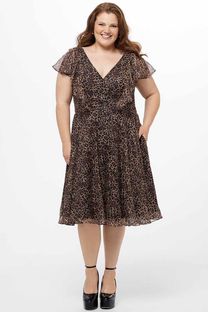 Celebrations by Sydney's Closet style CE2605 in animal print. 

Knee length plus size animal print dress.  V-neck, short flutter sleeves, natural waistline, pockets and ruffles on bodice princess seams. Made from printed chiffon and light satin lining. Center back zipper.