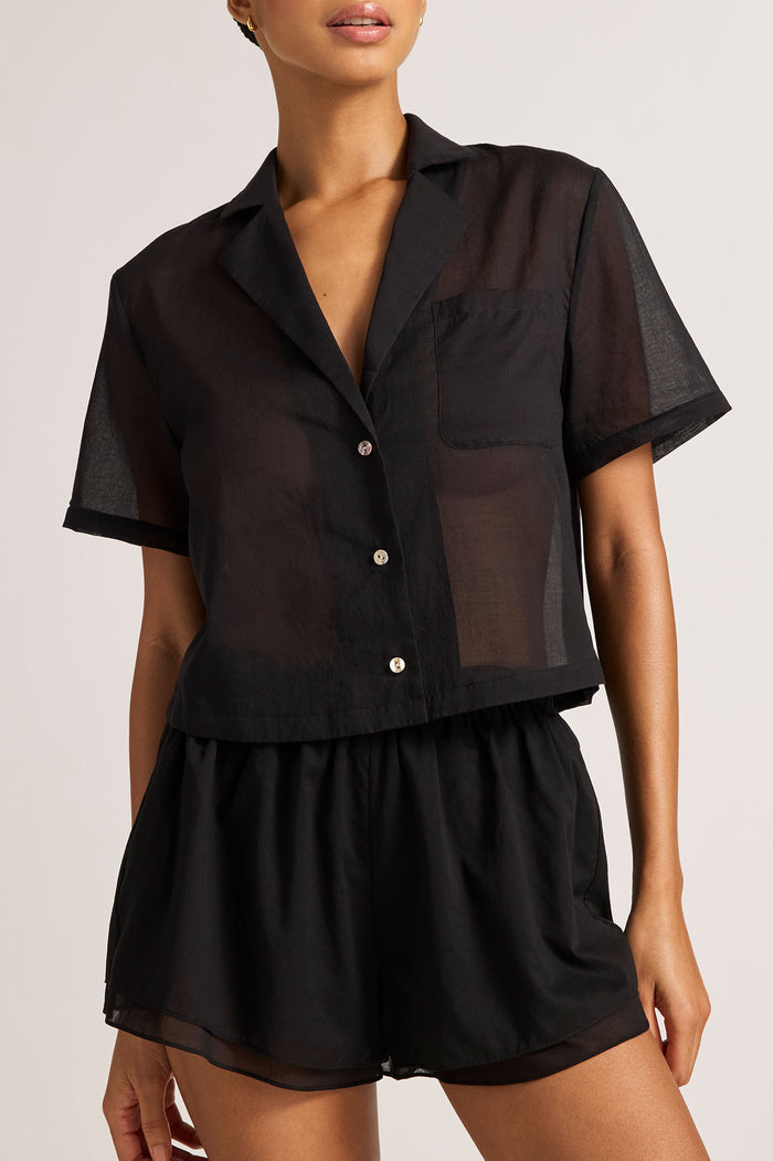 Black short-sleeve button-up shirt with collar, cropped silhouette
