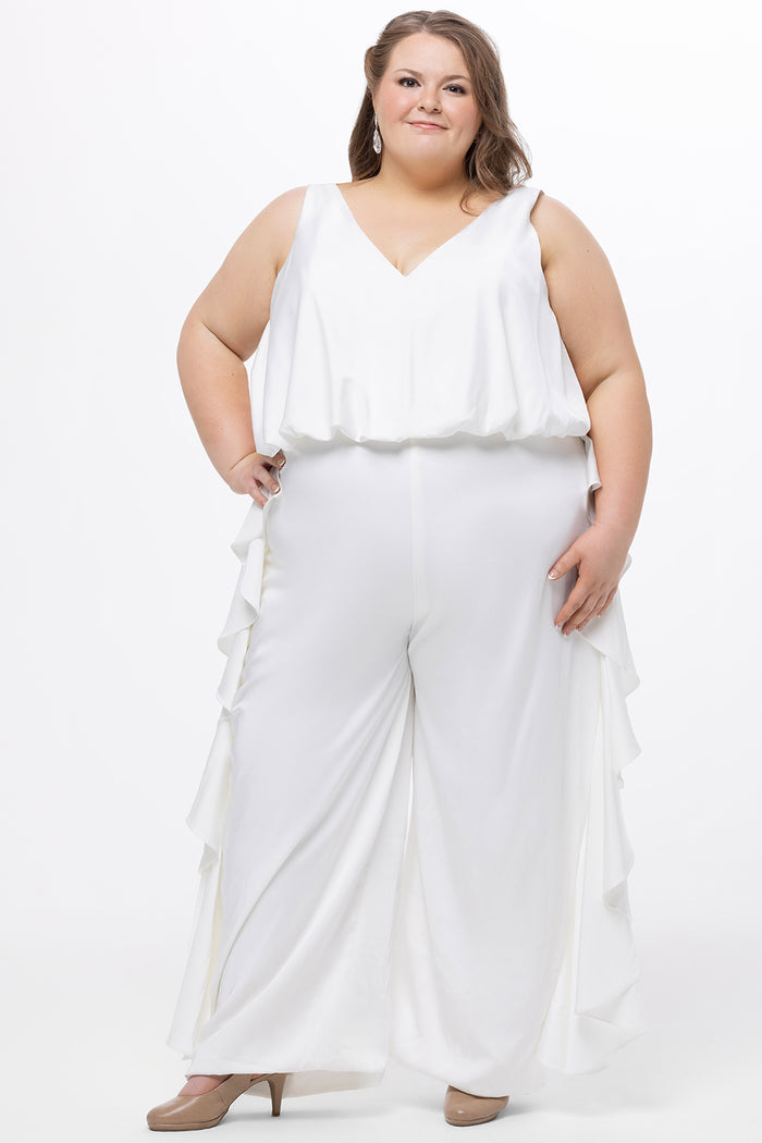 Celebration's by Sydney's Closet style CE2615 in Ivory. 

Crepe satin jumpsuit with a V-neck, bra-friendly straps, wide leg pants and blouson bodice. Ruffle detail on outer seams of pants. V-back with long center back zipper.