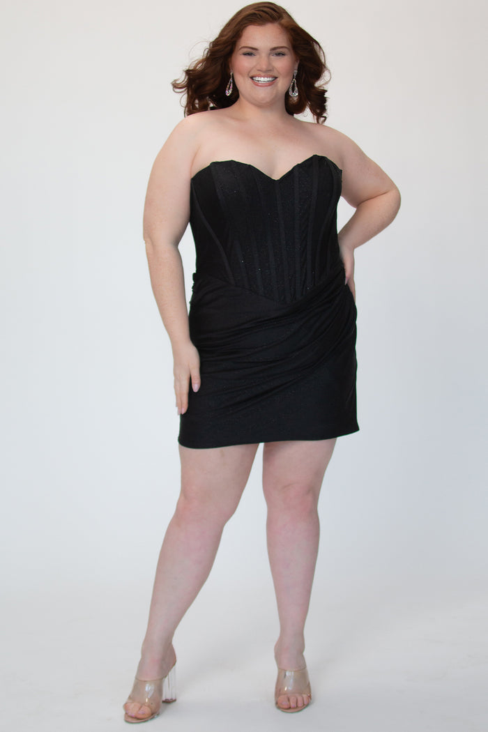 Short fitted black party dress SC8143 by Sydney's Closet. Front view.  Strapless, exposed boning basque waist and ruched fitted skirt in shimmer stretch knit. Availability in black, purple, red, ivory, green and royal. Model in picture is 5'9.