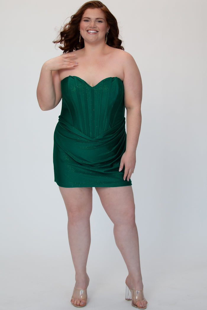 Short fitted green party dress SC8143 by Sydney's Closet. Front view.  Strapless, exposed boning basque waist and ruched fitted skirt in shimmer stretch knit. Long invisible center back zipper. Availability in black, purple, red, ivory, green and royal. Model in picture is 5'9.