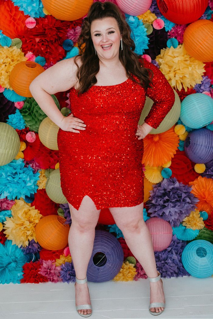 This is SC8112 in our Sydney's Closet Homecoming collection. This plus size party dress comes in green, black, white, red, and blue! This dress has one shoulder long sleeve, natural waistline, and a scoop neckline. This fitted all over sequin dress has a small slit above the right knee! This gown is set in stone for this homecoming season!