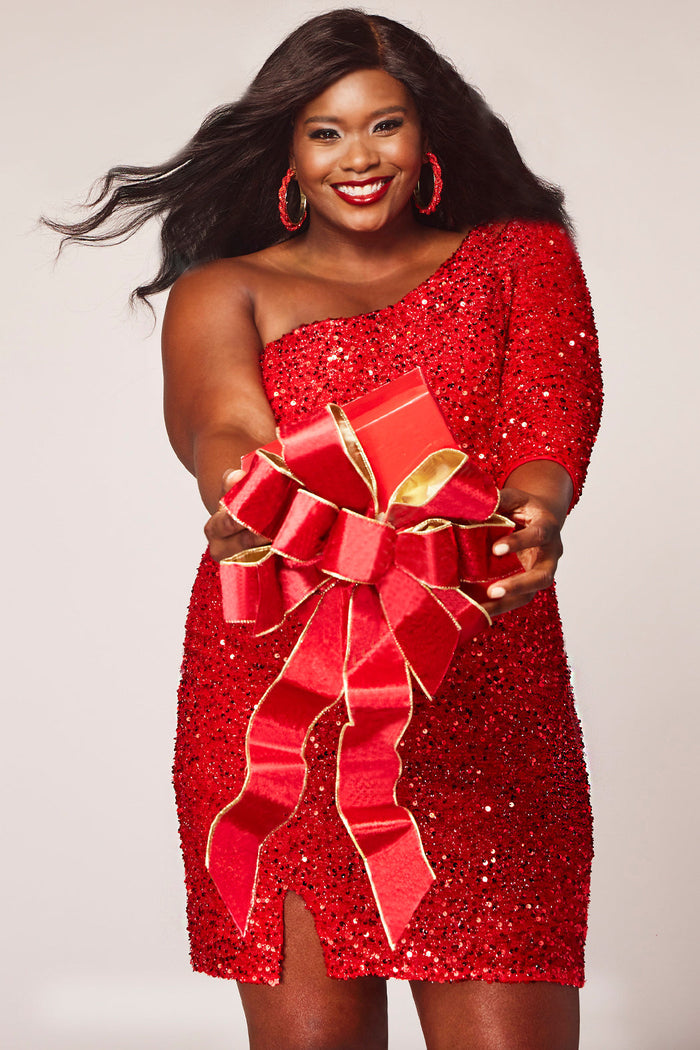 This is SC8112 in our Sydney's Closet Homecoming collection. This plus size party dress comes in green, black, white, red, and blue! This dress has one shoulder long sleeve, natural waistline, and a scoop neckline. This fitted all over sequin dress has a small slit above the right knee! This gown is set in stone for this homecoming season!