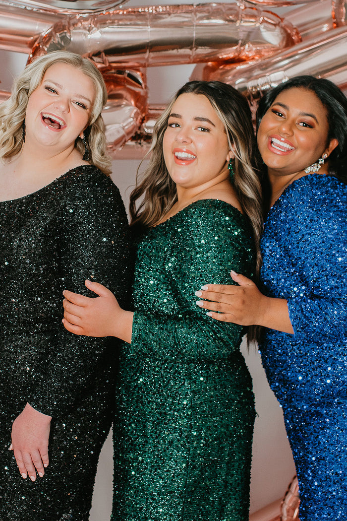 This is SC8112 in our Sydney's Closet Homecoming collection. This plus size party dress comes in green, black, white, red, and blue! This dress has one shoulder long sleeve, natural waistline, and a scoop neckline. This fitted all over sequin dress has a small slit above the right knee! This gown is set in stone for this homecoming season!