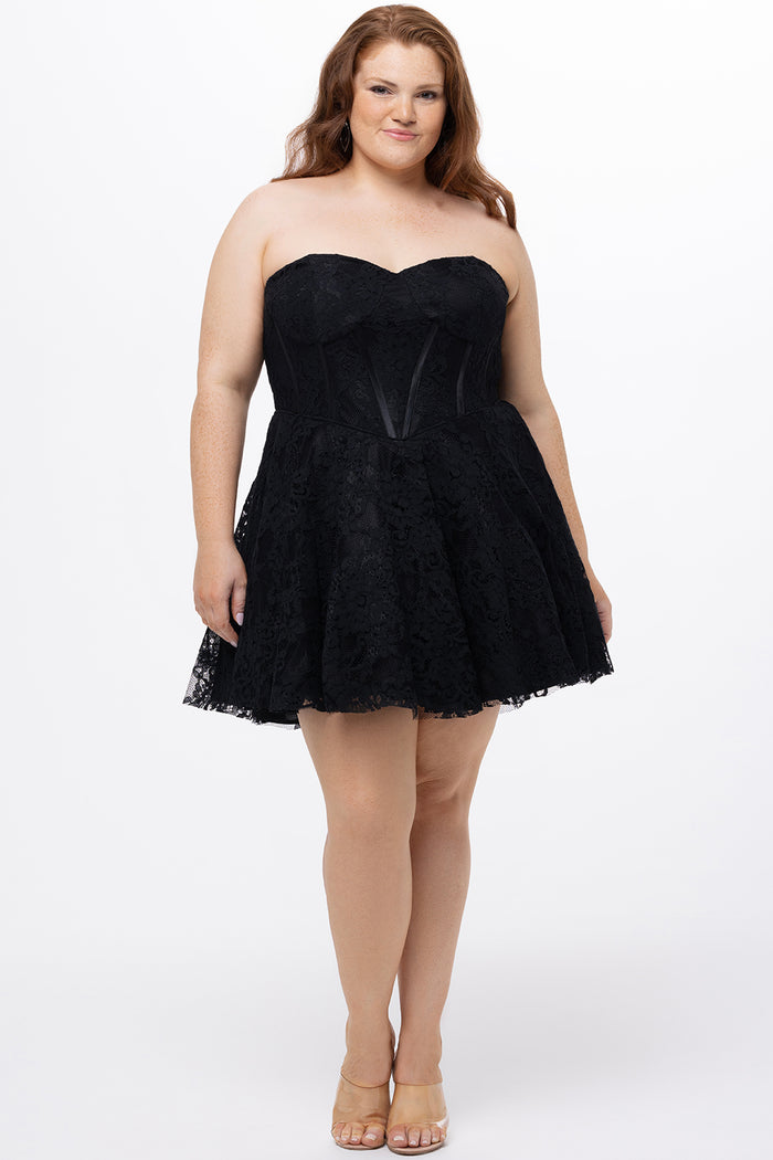 Celebrations by Sydney's Closet Style CE2612 in black. 

Plus size strapless black short mini party dress with sweetheart neckline, exposed corset boning on bustier bodice and mini skirt in all over stretch lace.