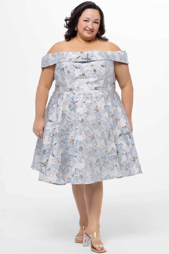 Celebrations by Sydney's Closet CE2610 in Light Blue Floral. 

Plus size knee-length party dress in metallic light blue floral brocde print. Off-the-shoulder neckline, natural waistline and A-line skirt with pockets.