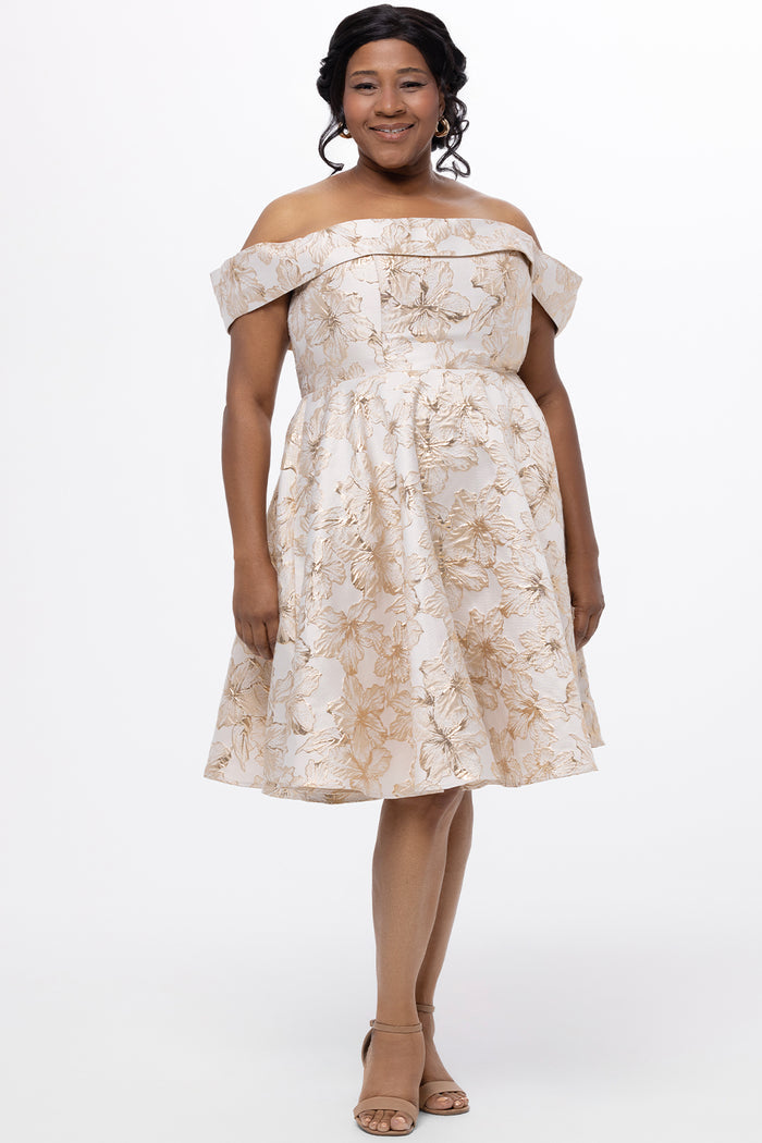 Celebrations by Sydney's Closet CE2610 in Gold Floral. 

Plus size knee-length party dress in metallic gold floral brocde print. Off-the-shoulder neckline, natural waistline and A-line skirt with pockets.