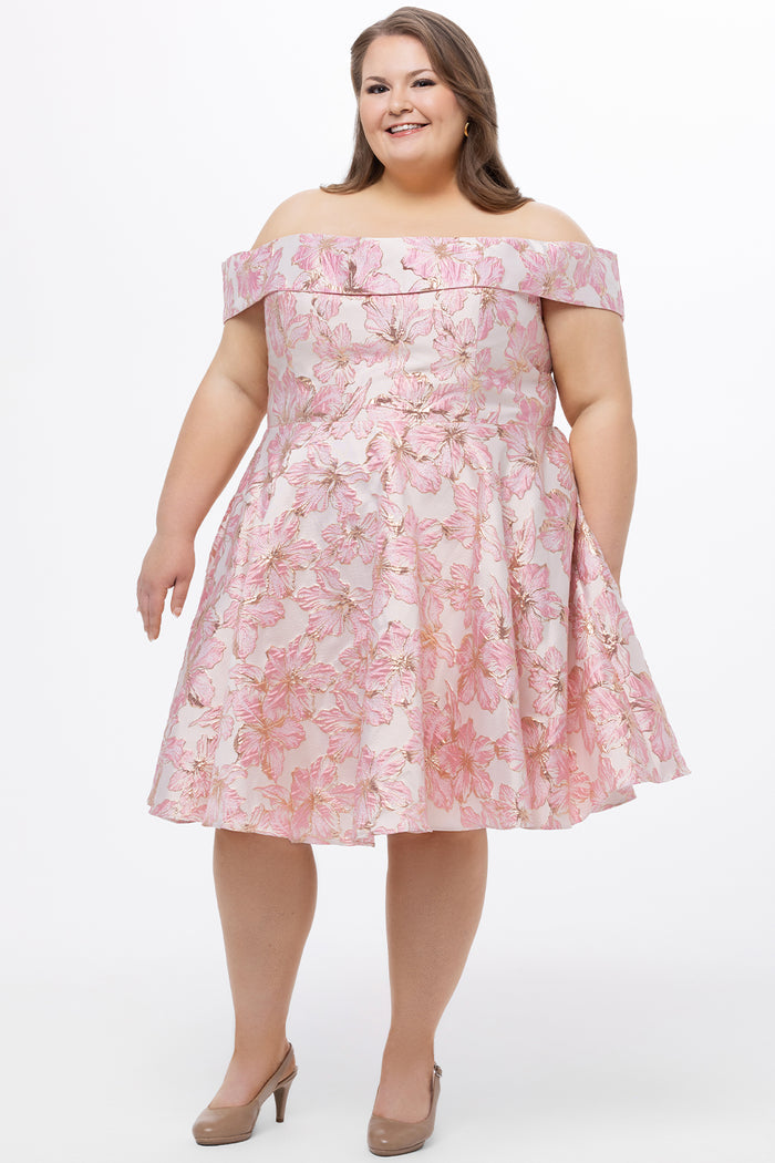 Celebrations by Sydney's Closet CE2610 in Light Pink Floral. 

Plus size knee-length party dress in metallic light pink floral brocde print. Off-the-shoulder neckline, natural waistline and A-line skirt with pockets.