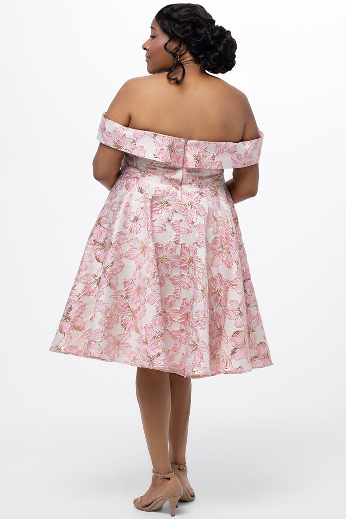 Celebrations by Sydney's Closet CE2610 in Light Pink Floral. 

Plus size knee-length party dress in metallic light pink floral brocde print. Off-the-shoulder neckline, natural waistline and A-line skirt with pockets.