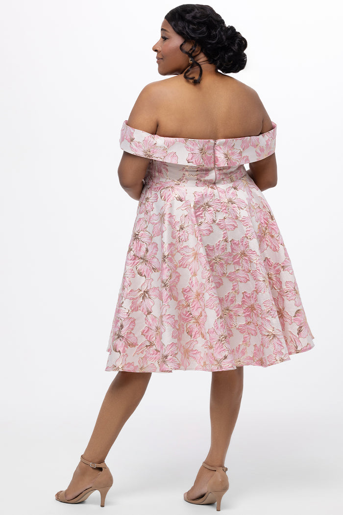 Celebrations by Sydney's Closet CE2610 in Light Pink Floral. 

Plus size knee-length party dress in metallic light pink floral brocde print. Off-the-shoulder neckline, natural waistline and A-line skirt with pockets.