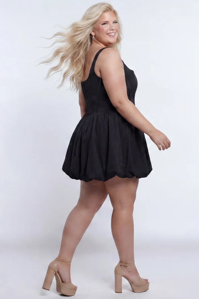 Plus-size model wearing a black sleeveless taffeta mini dress with a square neckline, structured corset-inspired bodice with exposed boning, and voluminous bubble hem skirt. She is styled with long flowing blonde hair, drop earrings, and nude platform ankle-strap heels, walking to the side against a light gray studio background. Back view.

Sydney's Closet SC8166 in black