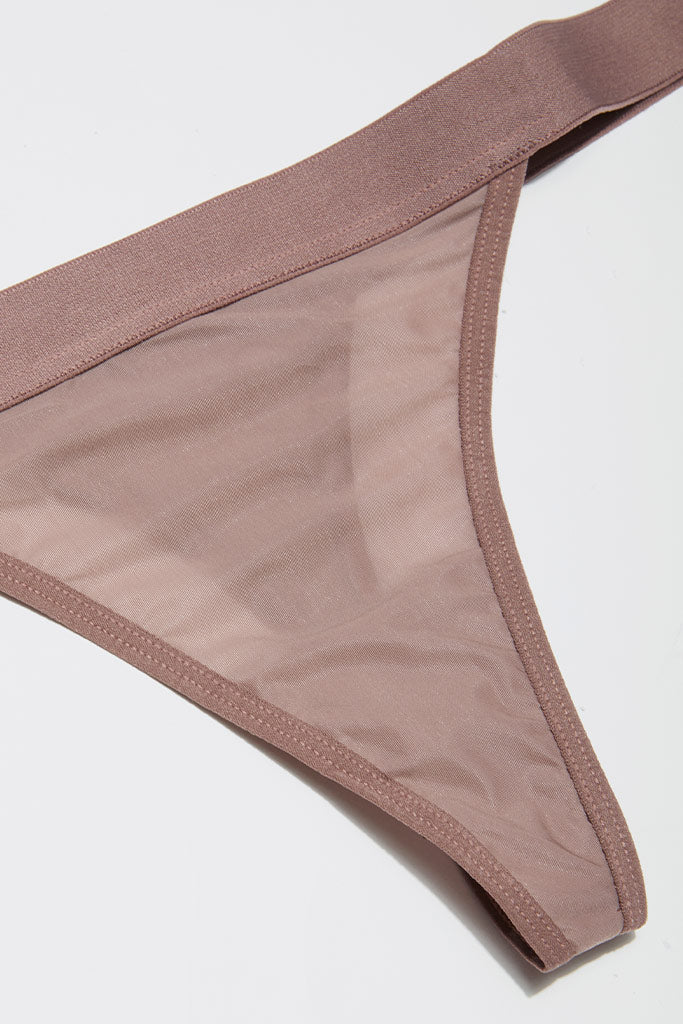 Silky thong underwear in muted mauve, sheer fabric with thin trim