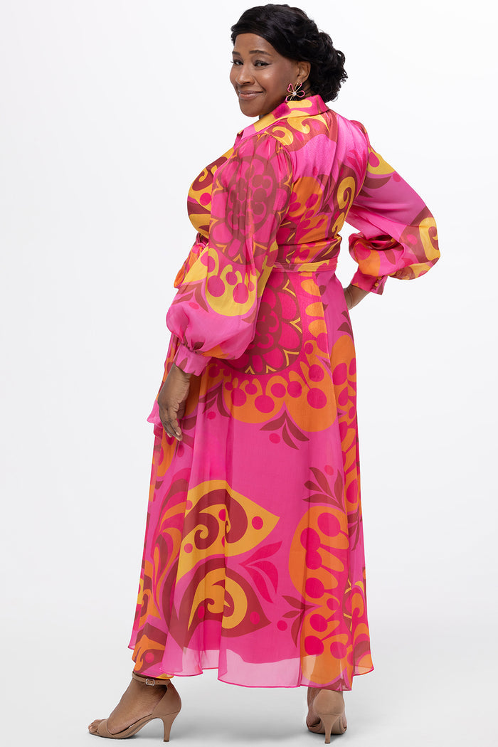 Celebration's by Sydney's Closet style CE2622 in abstract print. 

Button down plus size ankle length gown made from printed organza. V-neck, long pouf sleeves with cuff and optional belt. A-line skirt with pockets.