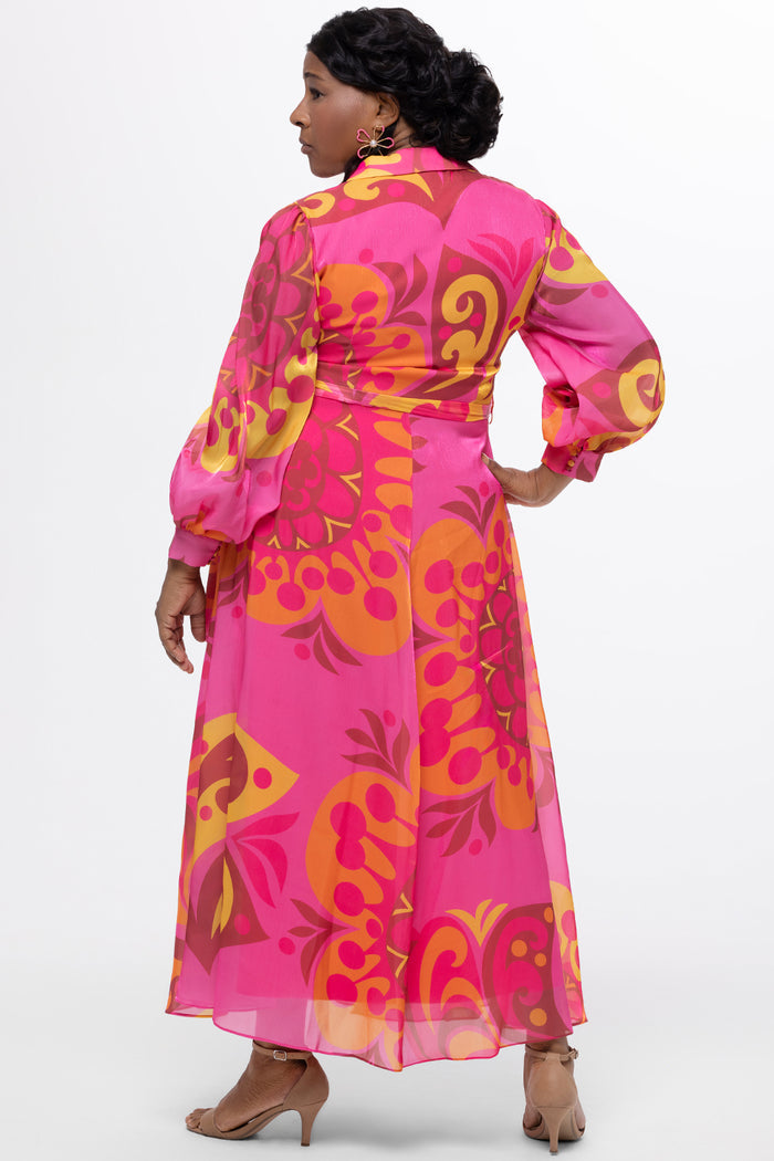 Celebration's by Sydney's Closet style CE2622 in abstract print. 

Button down plus size ankle length gown made from printed organza. V-neck, long pouf sleeves with cuff and optional belt. A-line skirt with pockets.