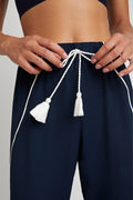 Navy jogger pants waistband with white drawstring and tassel, elastic waist