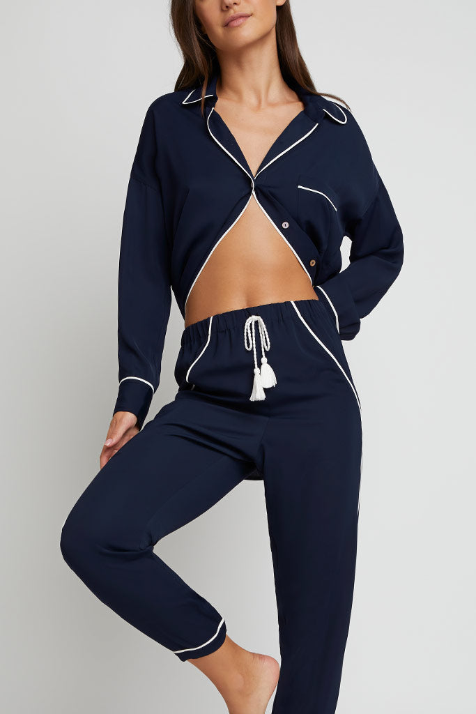 Navy jogger pants with white trim and drawstring waist, tapered legs
