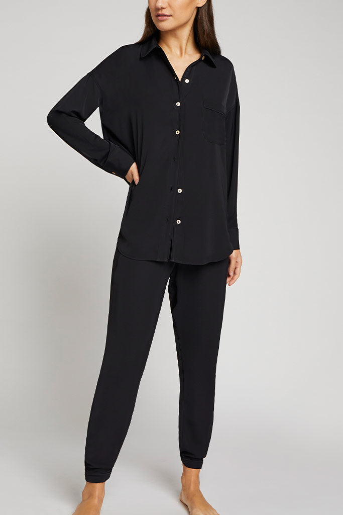 Black button-front shirt with chest pocket, long sleeves, gold buttons