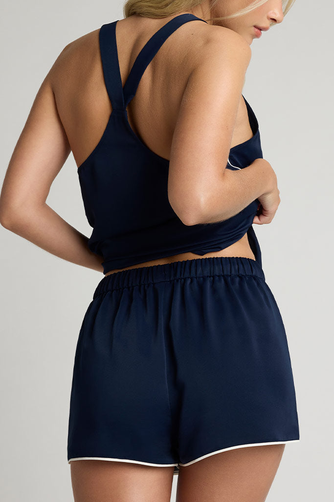 Navy drawstring shorts with elastic waistband, white trim, back view