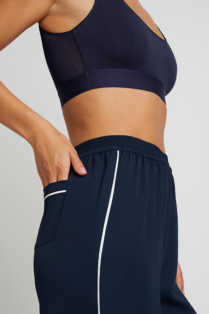 Navy track pants with elastic waistband and white side stripe