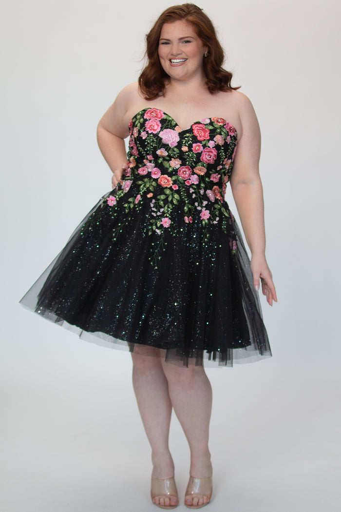 SC8137 Front view. Black sparkle tulle short a-line party dress with pink floral embroidered roses. Strapless sweetheart neckline, long invisible center back zipper.  Available only in black floral. Curvy sizes 10-32. Model in picture is 5 foot 9 inches and a size 16.