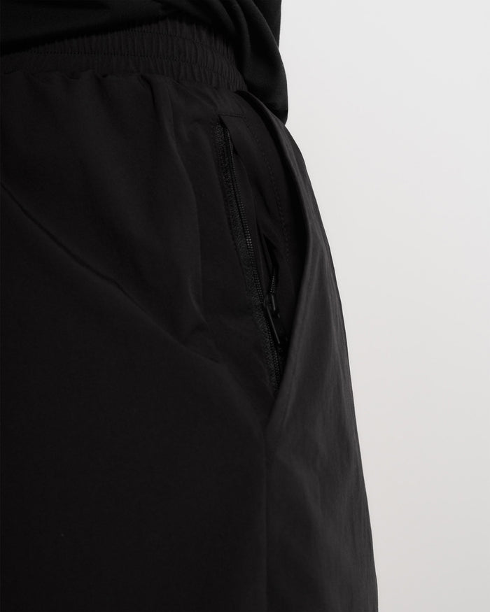 Man wearing black 2-in-1 shorts on a plain white background | Team 247 2-In-1 Shorts in Black | Shorts with inside leggings and zip pockets | 247 Shorts | Represent Clo
