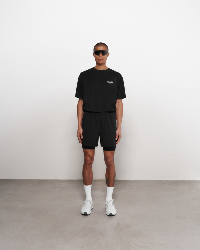 Man wearing black shorts on a plain white background | Team 247 2-In-1 Shorts in Black | Shorts with inside leggings and zip pockets | 247 Shorts | Represent Clo