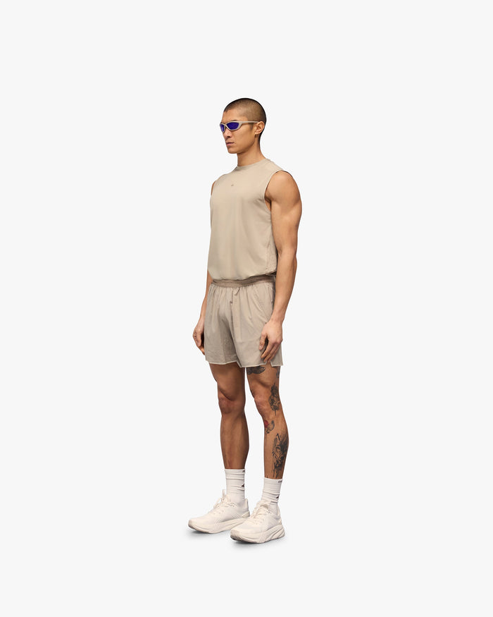Man wearing grey shorts on a plain white background | Team 247 Aero Shorts in Pebble | Lightweight breathable running shorts | 247 Shorts | Represent Clo
