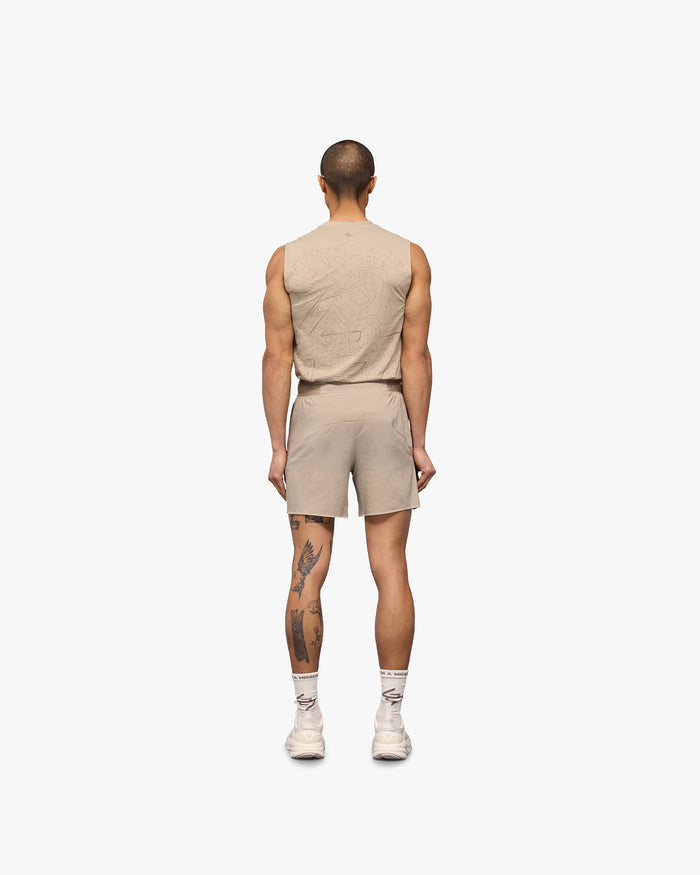 Man wearing grey running shorts on a plain white background | Team 247 Aero Shorts in Pebble | Lightweight breathable running shorts | 247 Shorts | Represent Clo