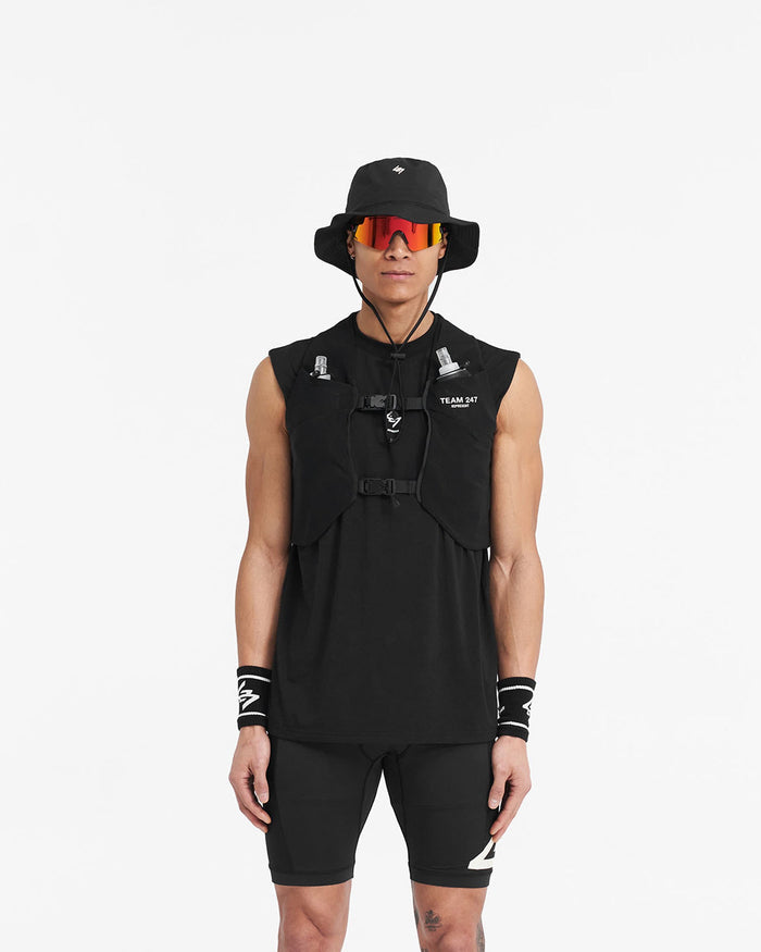 Man wearing a black chest rig on a plain white background | Team 247 Chest Rig in Black | Chest rig with mesh outer and magnetic buckles | 247 Accessories | Represent Clo