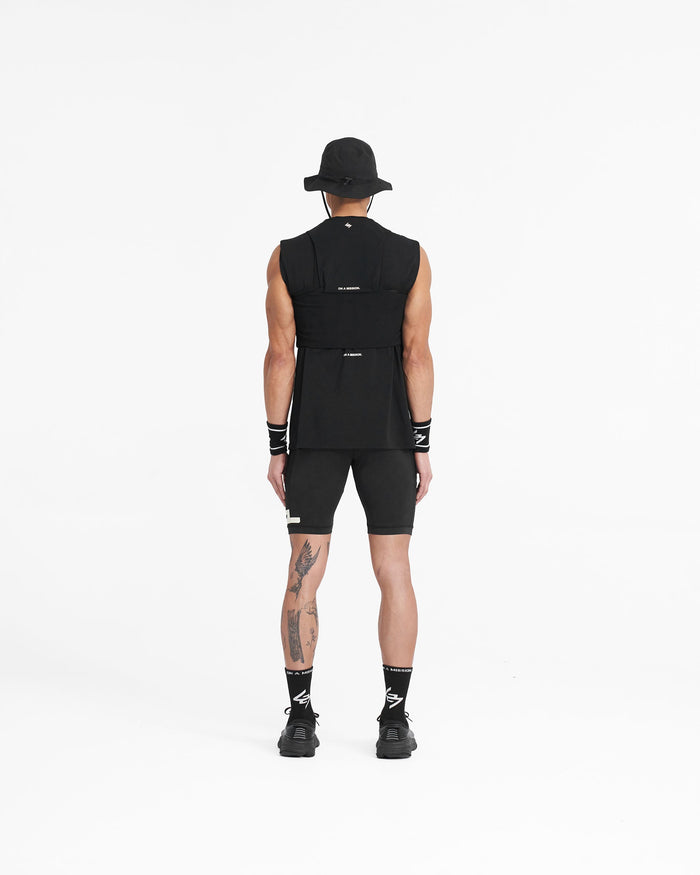Model wearing a mens black chest rig on a plain white background | Team 247 Chest Rig in Black | Chest rig with magnetic buckles and multiple mesh pockets | 247 Accessories | Represent Clo