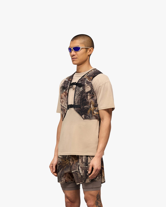 Detailed product image of a mens chest rig in camo on a plain white background | Team 247 Chest Rig in Realtree | Mesh chest rig with magnetic buckle and multiple mesh pockets | 247 Accessories | Represent Clo