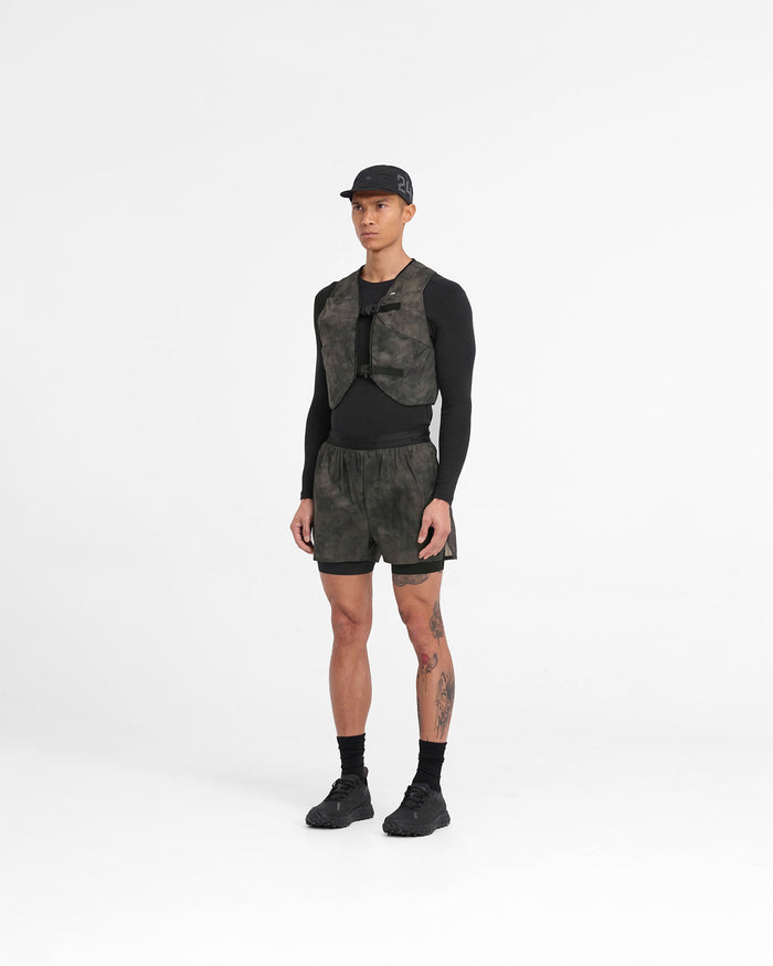 Person wearing a mens brown chest rig on a plain white background | Team 247 Chest Rig in Terrain | Mesh chest rig with magnetic buckles and multiple pockets | 247 Accessories | Represent Clo