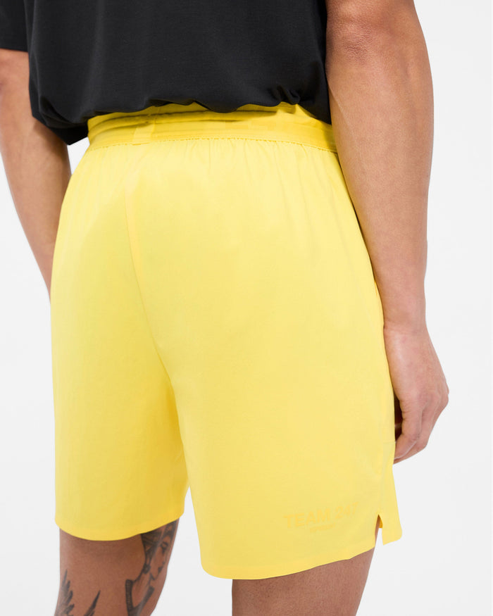 Man wearing yellow gym shorts on a plain white background | Team 247 Fused Shorts in Lemon | Durable shorts with 4-way stretch | 247 Shorts | Represent Clo