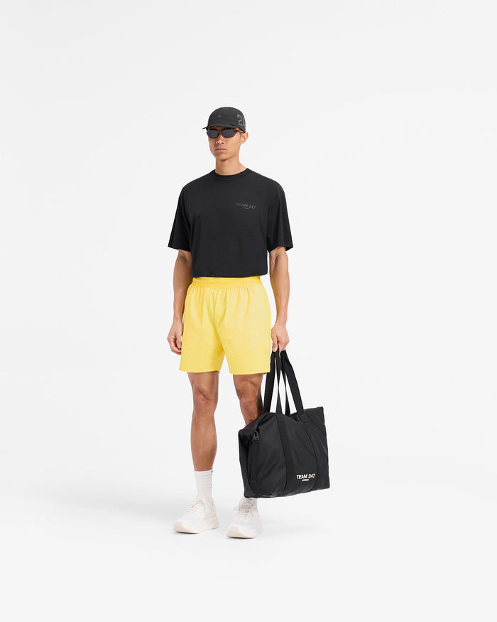 Man wearing yellow shorts on a plain white background | Team 247 Fused Shorts in Lemon | Gym shorts with internal drawcords | 247 Shorts | Represent Clo