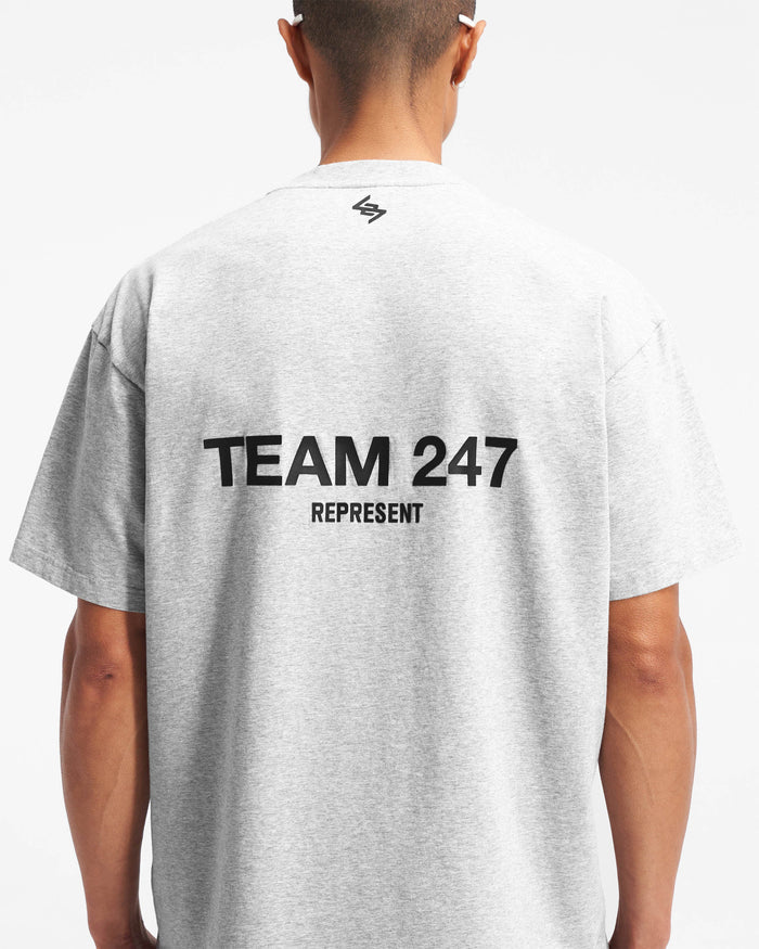 Man wearing an oversized grey t-shirt on a plain white background | Team 247 Oversized T-Shirt in Ash Grey | Lightweight breathable gym top with 4-way stretch | 247 T-Shirts | Represent Clo