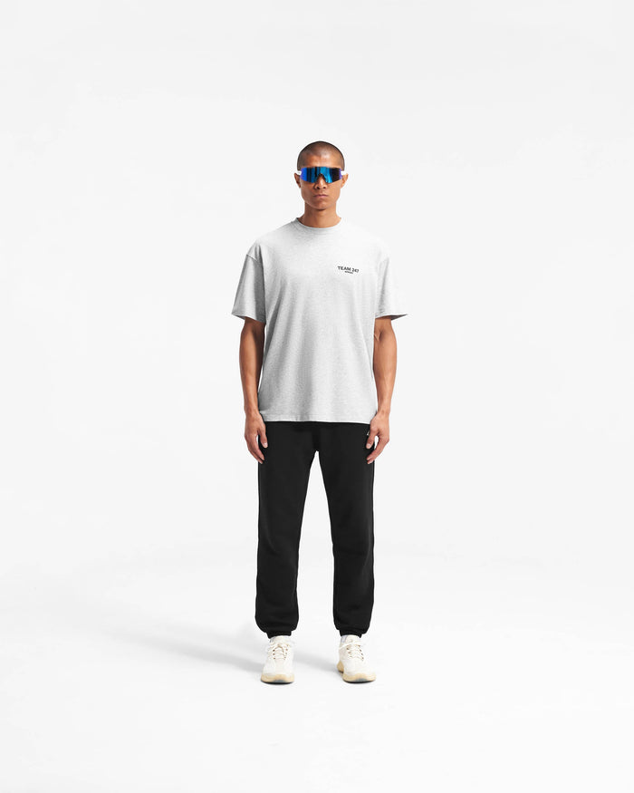 Man wearing an oversized grey t-shirt on a plain white background | Team 247 Oversized T-Shirt in Ash Grey | Lightweight and breathable gym top with quick drying feature | 247 T-Shirts | Represent Clo